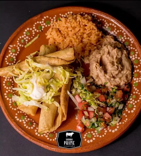 Crispy taquitos with rice, beans, lettuce and pico de gallo